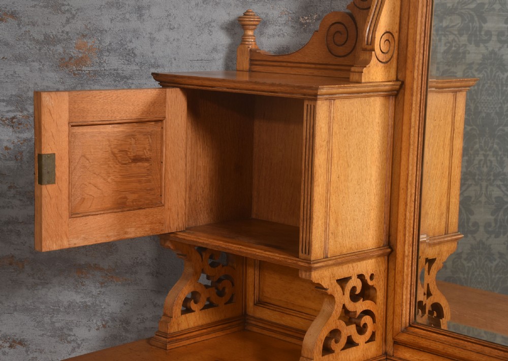 An oak dressing table featuring marquetry inlay patterns on the drawers and side cabinets, a central rectangular mirror, turned legs, and an H-stretcher. View XII