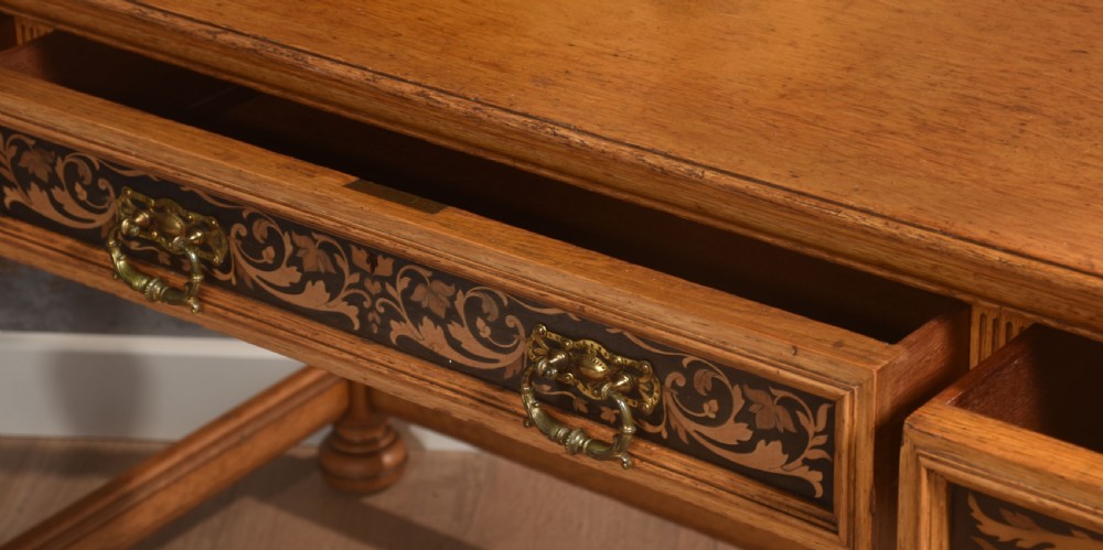 An oak dressing table featuring marquetry inlay patterns on the drawers and side cabinets, a central rectangular mirror, turned legs, and an H-stretcher. View XIV