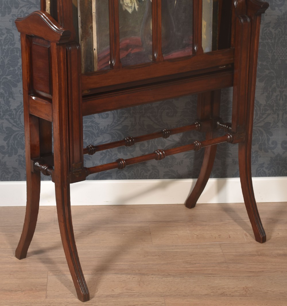 An antique warm brown walnut folio stand featuring vertical slatted supports, turned stretchers, panelled sides, and splayed legs. View V