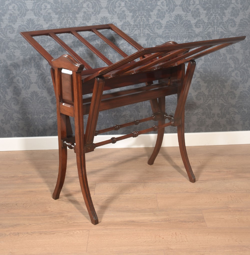 An antique warm brown walnut folio stand featuring vertical slatted supports, turned stretchers, panelled sides, and splayed legs. View VII