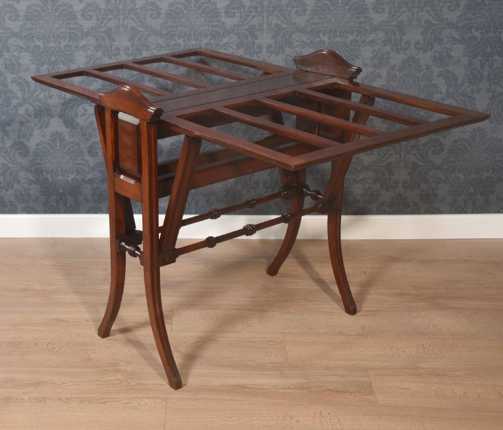 An antique warm brown walnut folio stand featuring vertical slatted supports, turned stretchers, panelled sides, and splayed legs. View VIII