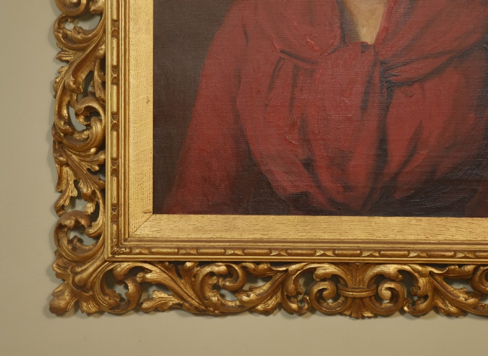 An oil painting depicting a lady in a red draped garment set within an ornate carved gilt frame. View IV