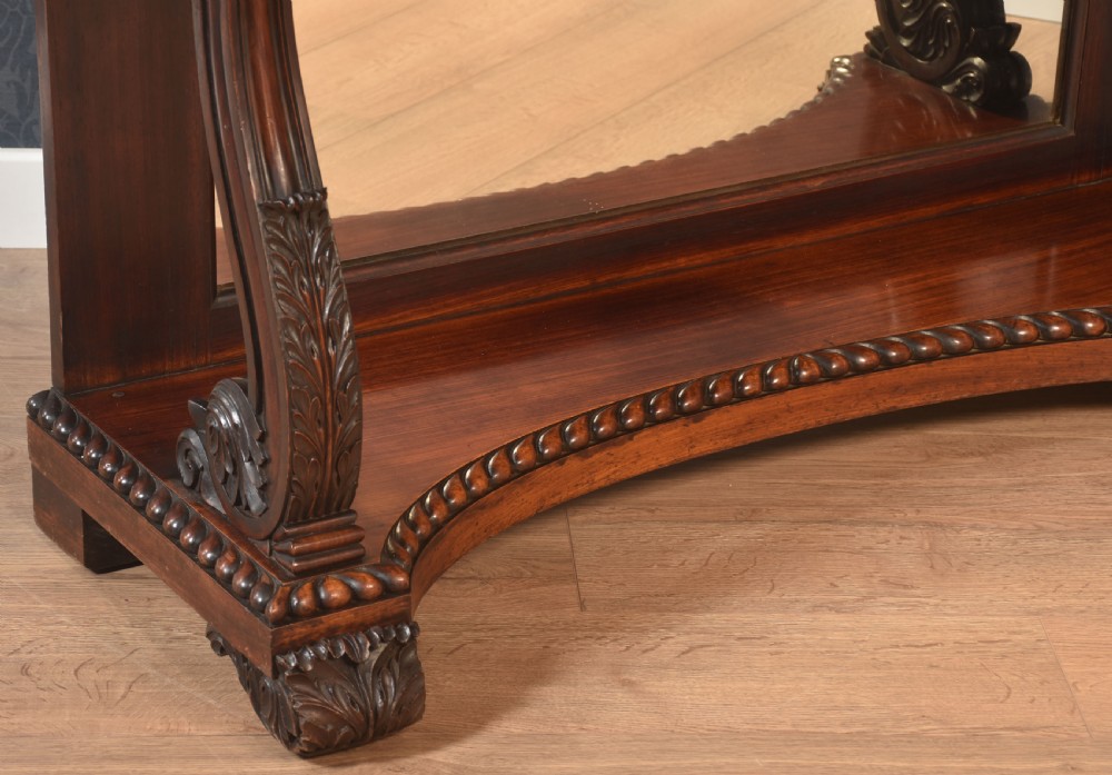 A 19th-century mahogany console table with a rectangular white marble top, carved frieze, S-shaped scroll supports, and an inset mirror back above a shaped plinth base. View III