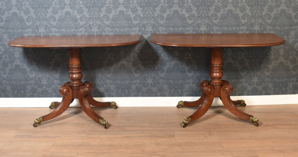 A pair of Regency mahogany semi-oval hall tables on reeded pedestal legs with brass claw feet. View III