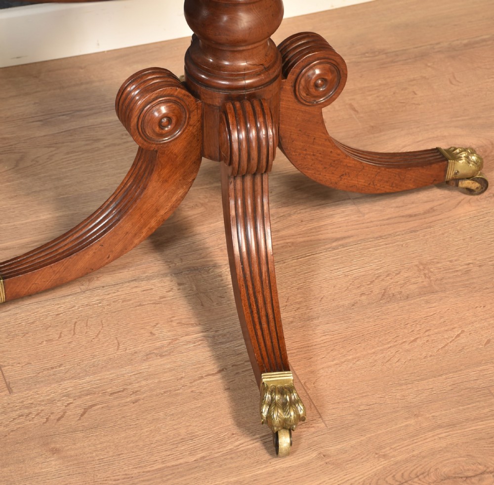 A pair of Regency mahogany semi-oval hall tables on reeded pedestal legs with brass claw feet. View IV