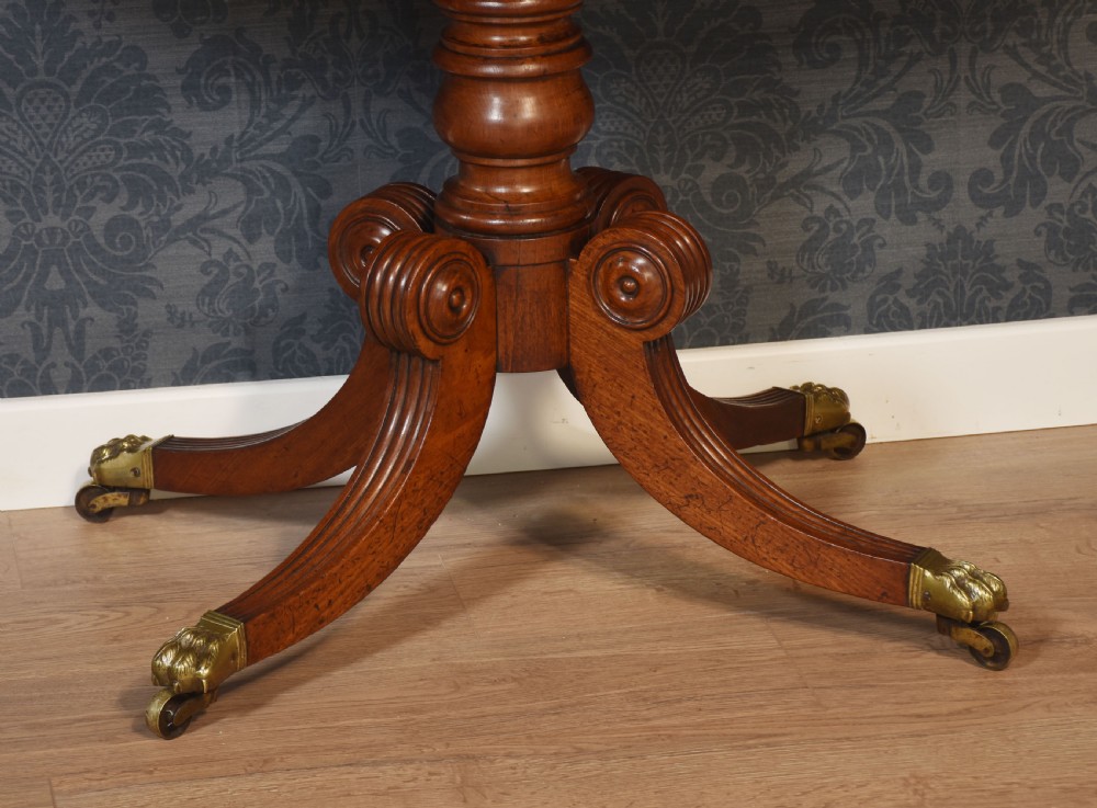 A pair of Regency mahogany semi-oval hall tables on reeded pedestal legs with brass claw feet. View VI