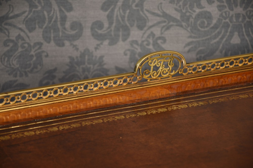 A 19th-century kingwood writing table featuring five drawers, ornate ormolu mounts, cabriole legs, and a leather-inset writing surface. View V