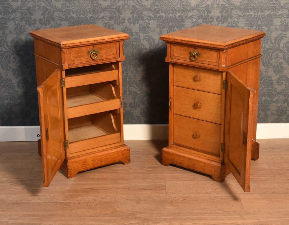 A matching pair of golden oak bedside cabinets featuring single top drawers with brass ring pulls and lower cupboard doors with diagonal plank detailing. View VI