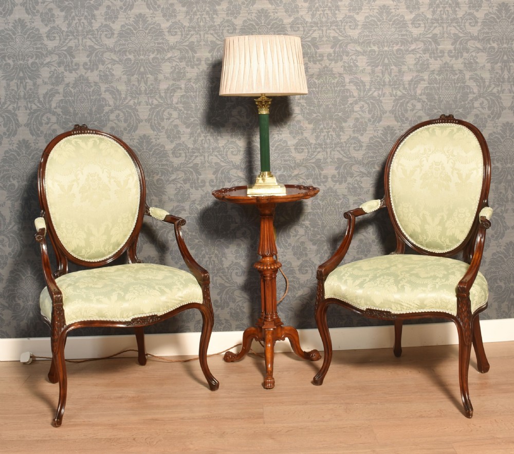 A pair of antique mahogany open armchairs featuring oval backrests, cabriole legs, and pale sage green damask upholstery. View II