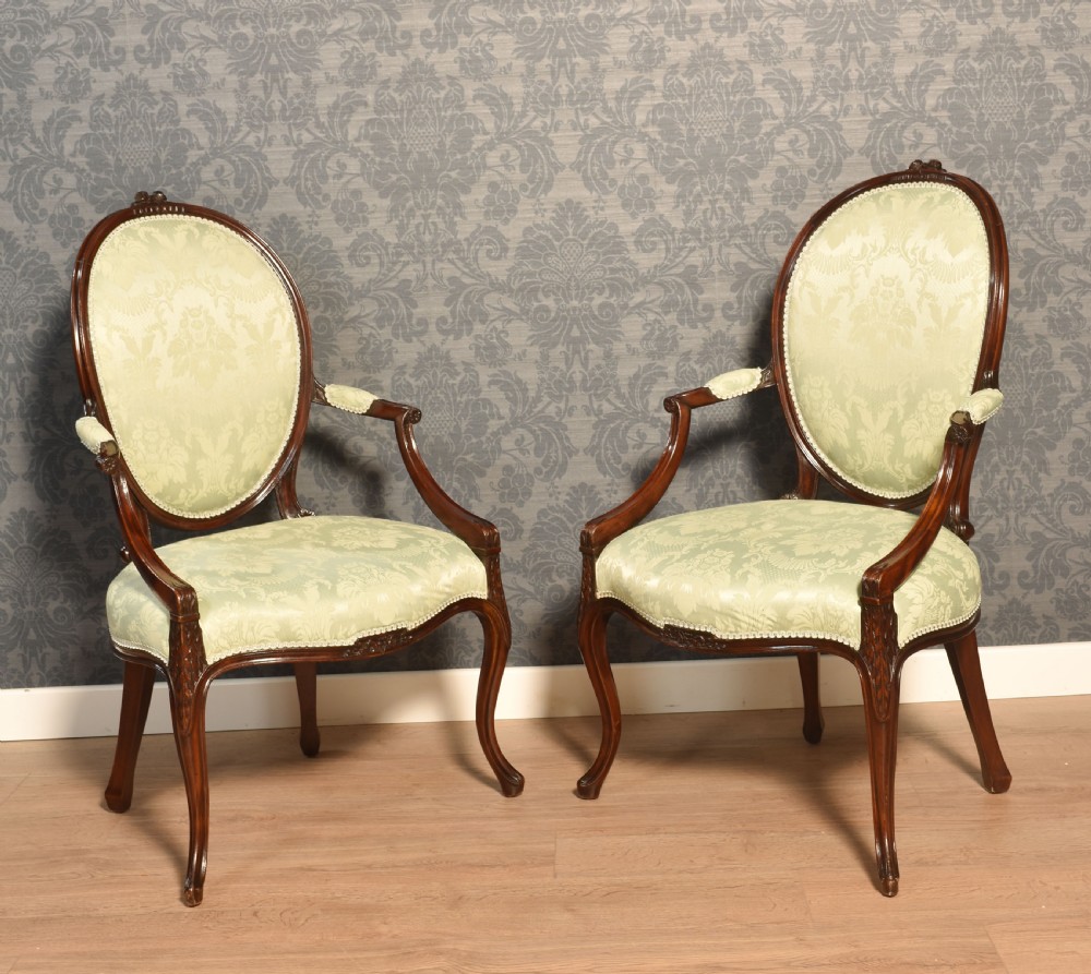 A pair of antique mahogany open armchairs featuring oval backrests, cabriole legs, and pale sage green damask upholstery. View VII
