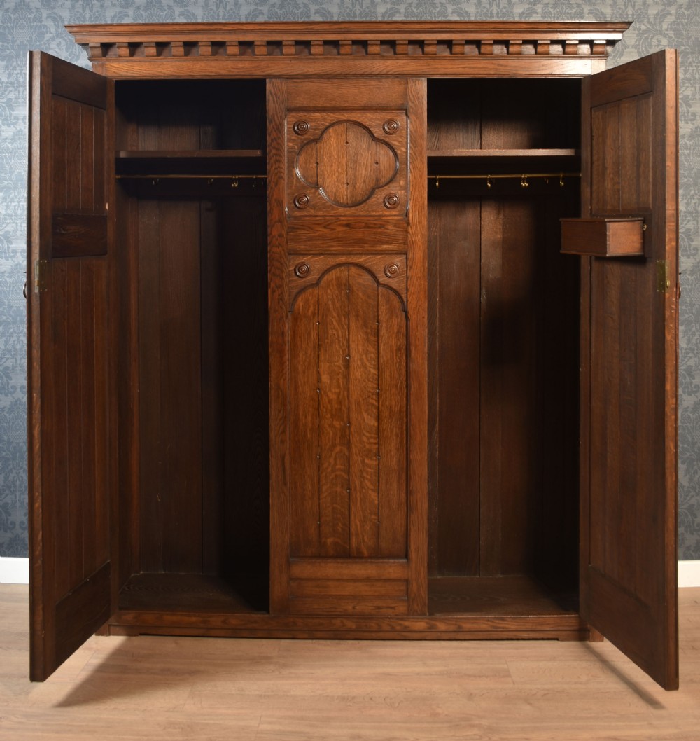 Jacobean style carved oak three door wardrobe View IV