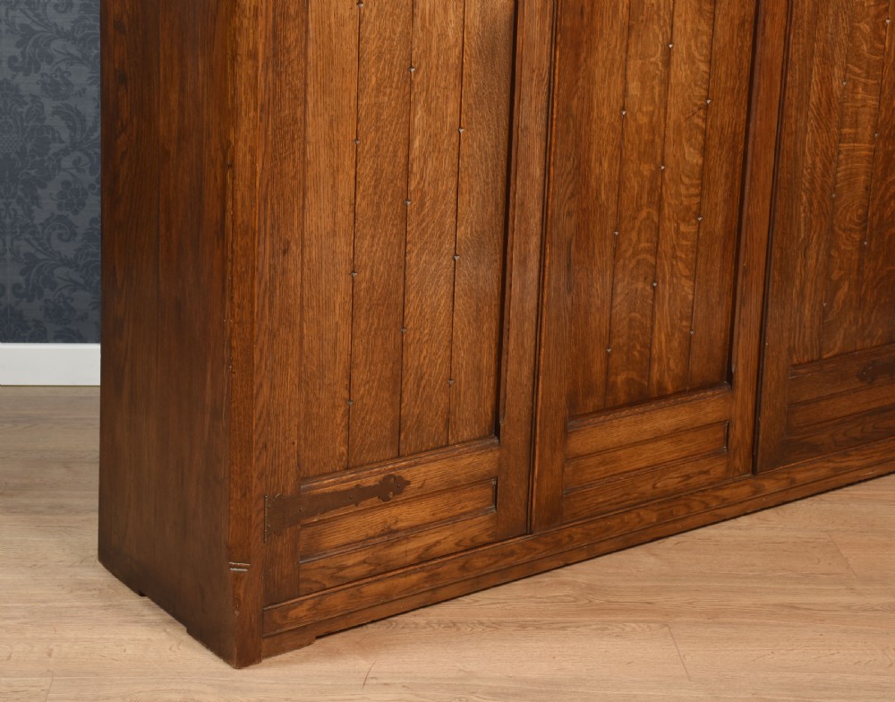 Jacobean style carved oak three door wardrobe View VI