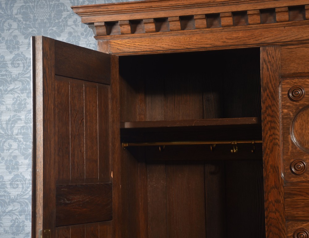 Jacobean style carved oak three door wardrobe View VII