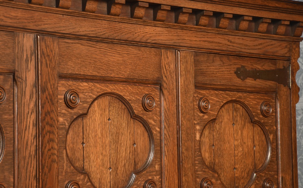 Jacobean style carved oak three door wardrobe View IX