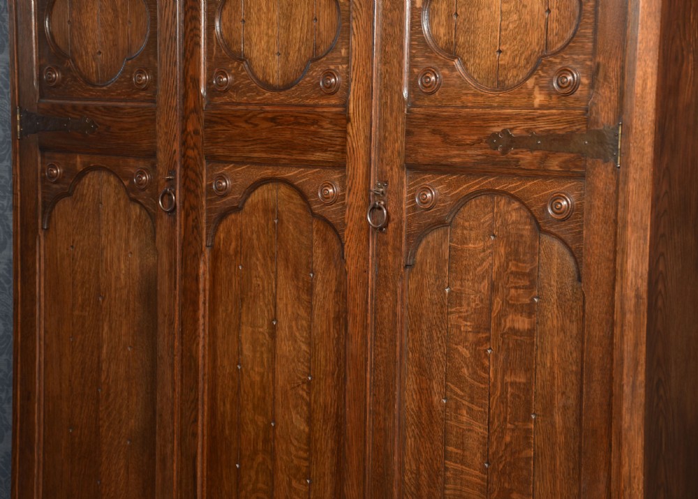 Jacobean style carved oak three door wardrobe View X