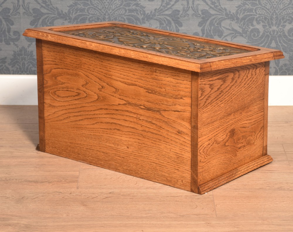 A Victorian slant-front oak slipper box featuring relief-embossed copper panels with cherubs on the front and a floral motif on the lid. View IV