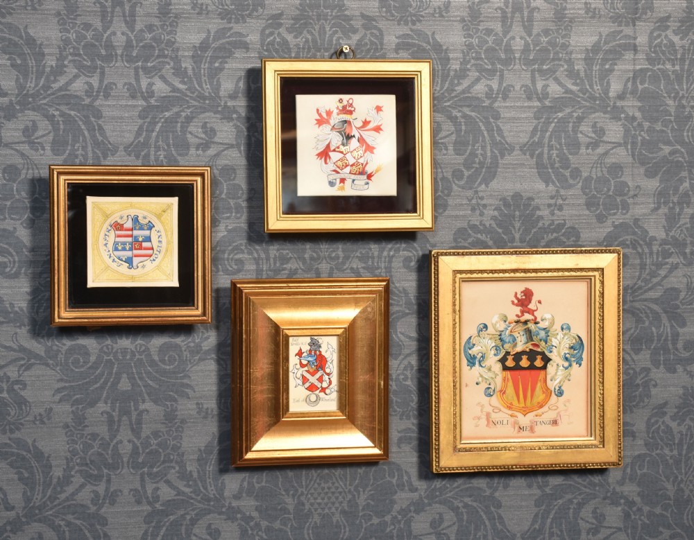 Collection of four framed coats of arms