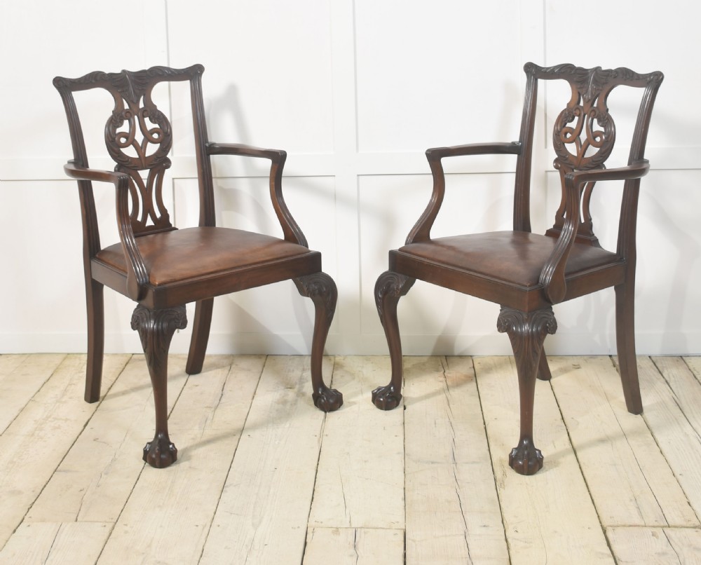 A set of eight mahogany Chippendale style dining chairs with carved splats, leather seats, and cabriole legs with ball-and-claw feet. View II