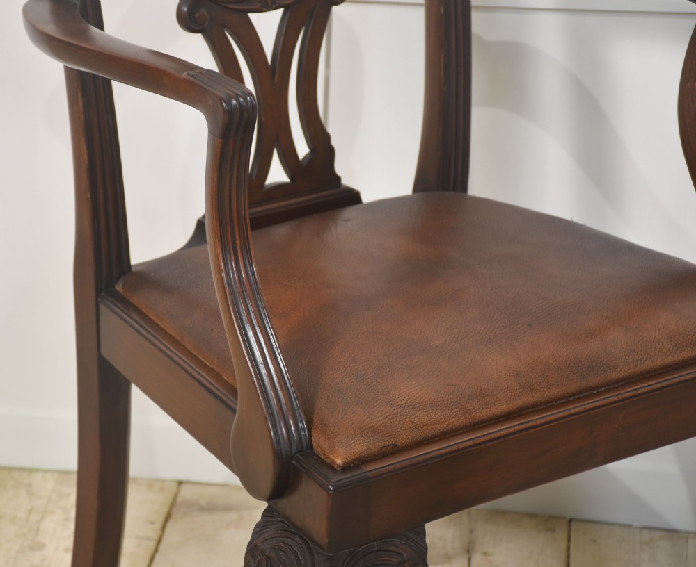A set of eight mahogany Chippendale style dining chairs with carved splats, leather seats, and cabriole legs with ball-and-claw feet. View III