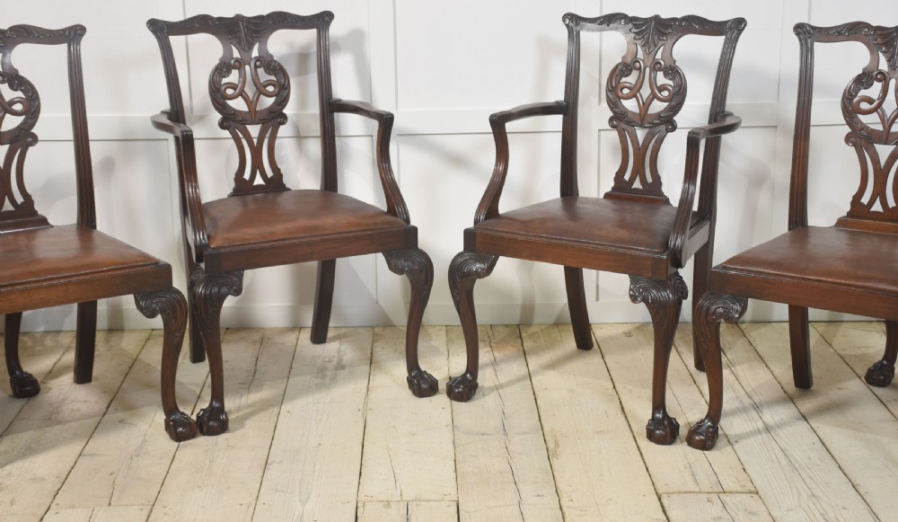 A set of eight mahogany Chippendale style dining chairs with carved splats, leather seats, and cabriole legs with ball-and-claw feet. View VII