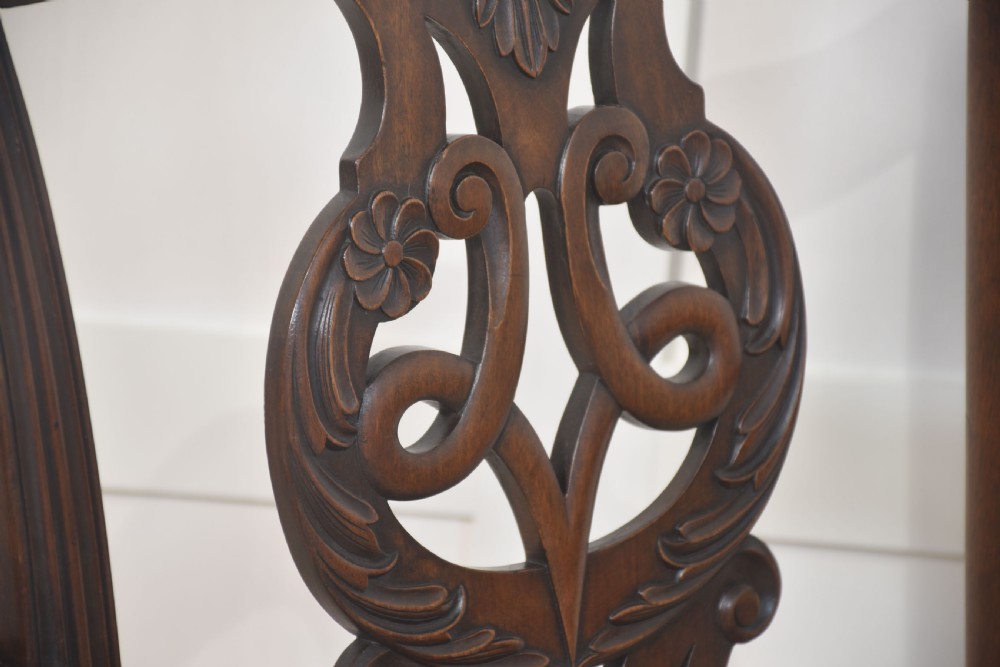 A set of eight mahogany Chippendale style dining chairs with carved splats, leather seats, and cabriole legs with ball-and-claw feet. View VIII