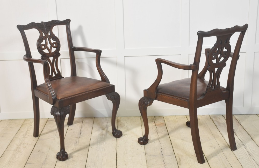 A set of eight mahogany Chippendale style dining chairs with carved splats, leather seats, and cabriole legs with ball-and-claw feet. View IX