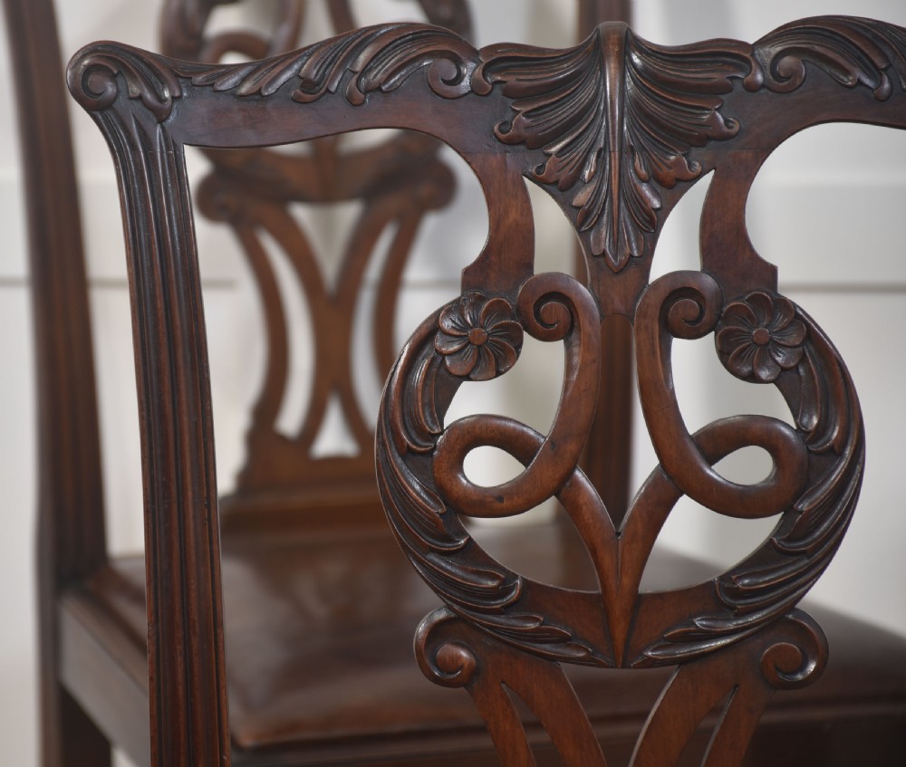 A set of eight mahogany Chippendale style dining chairs with carved splats, leather seats, and cabriole legs with ball-and-claw feet. View XII