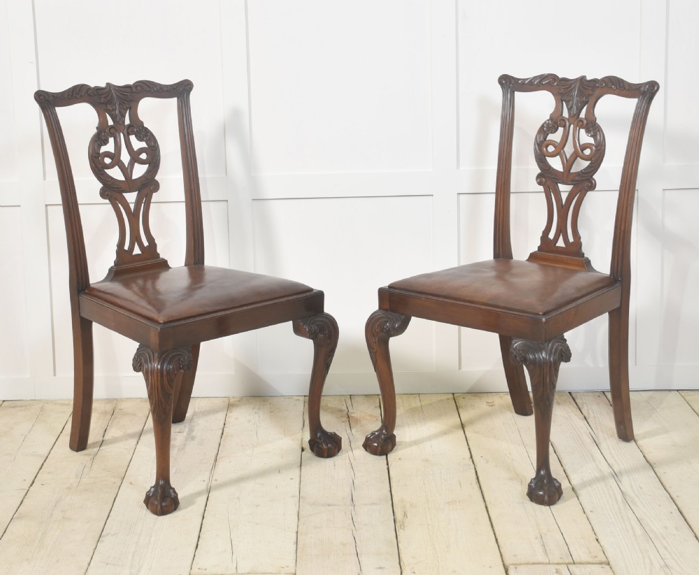 A set of eight mahogany Chippendale style dining chairs with carved splats, leather seats, and cabriole legs with ball-and-claw feet. View XIII