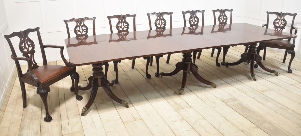 A set of eight mahogany Chippendale style dining chairs with carved splats, leather seats, and cabriole legs with ball-and-claw feet. View XIV