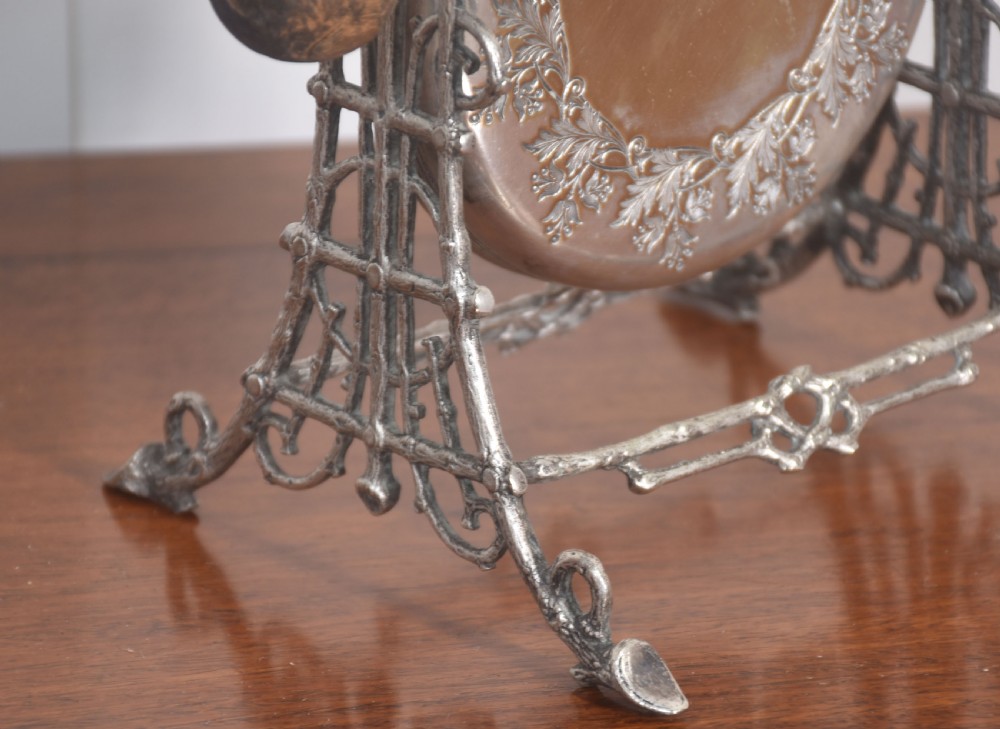 An Aesthetic Movement silver-plated table gong set within a naturalistic branch-like frame with a leaf-patterned circular gong and wooden striker. View II