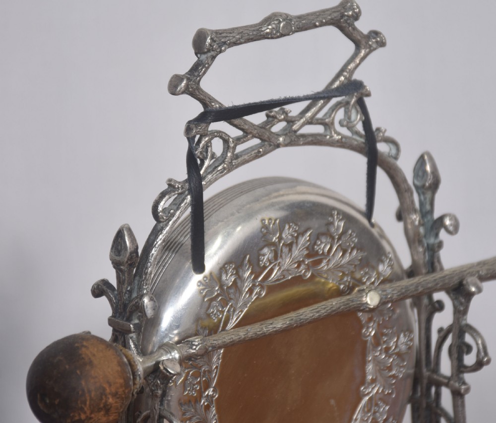 An Aesthetic Movement silver-plated table gong set within a naturalistic branch-like frame with a leaf-patterned circular gong and wooden striker. View VII