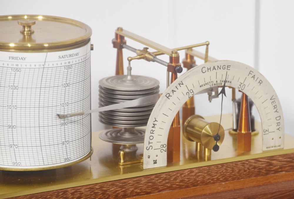 An antique mahogany-cased barograph with glass panels showing a revolving chart drum, brass mechanism, and silvered weather indicator arc. View V