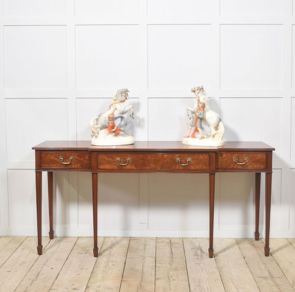 A pair of glazed cream and grey porcelain figures depicting rearing horses held by handlers on naturalistic bases. View III
