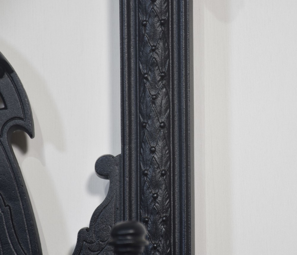 An ornate black cast iron hall stand featuring intricate scrollwork, coat hooks, an umbrella holder, and a fitted drip tray. View VIII
