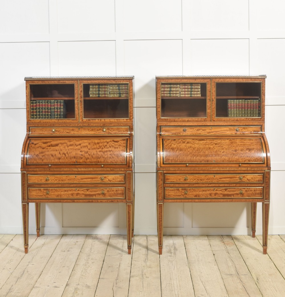 A pair of Georgian satinwood cylinder bureau cabinets with upper glazed doors, roll-top writing sections, and square tapered legs. View II