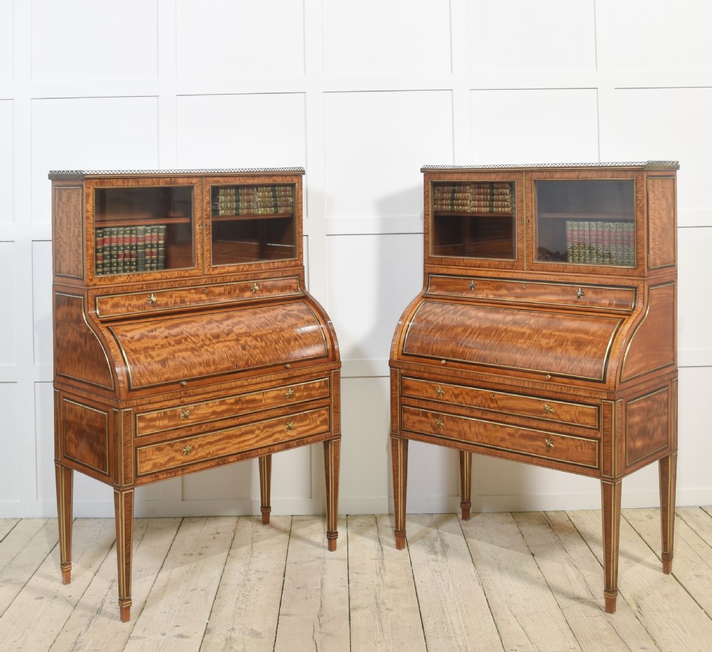 A pair of Georgian satinwood cylinder bureau cabinets with upper glazed doors, roll-top writing sections, and square tapered legs. View VIII