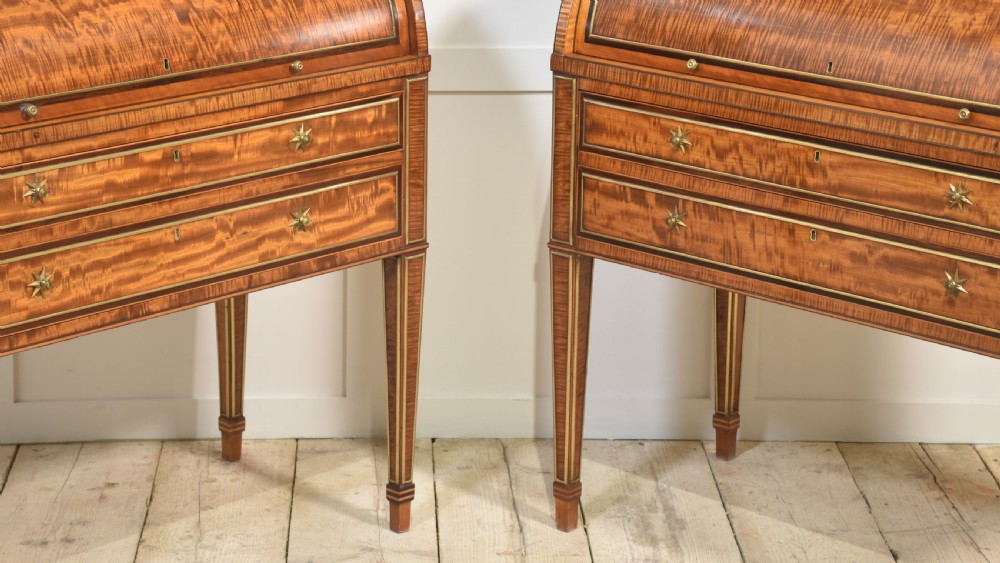 A pair of Georgian satinwood cylinder bureau cabinets with upper glazed doors, roll-top writing sections, and square tapered legs. View IX