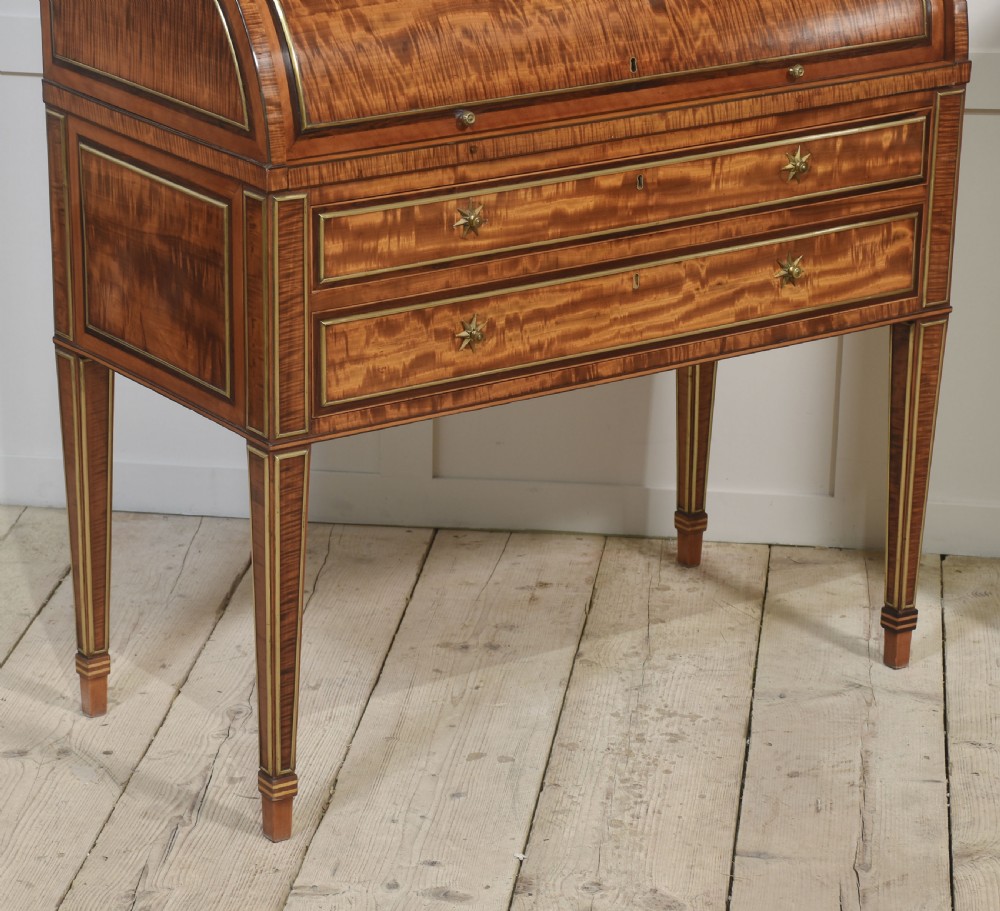 A pair of Georgian satinwood cylinder bureau cabinets with upper glazed doors, roll-top writing sections, and square tapered legs. View X