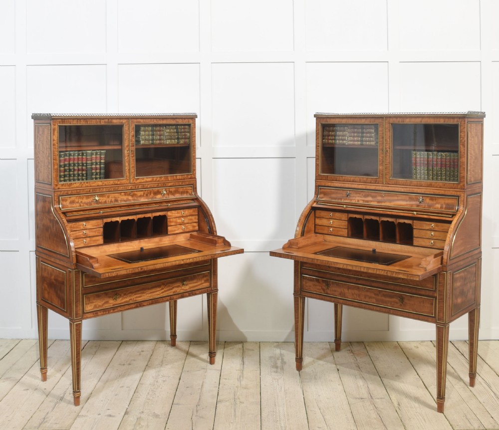 A pair of Georgian satinwood cylinder bureau cabinets with upper glazed doors, roll-top writing sections, and square tapered legs. View XI