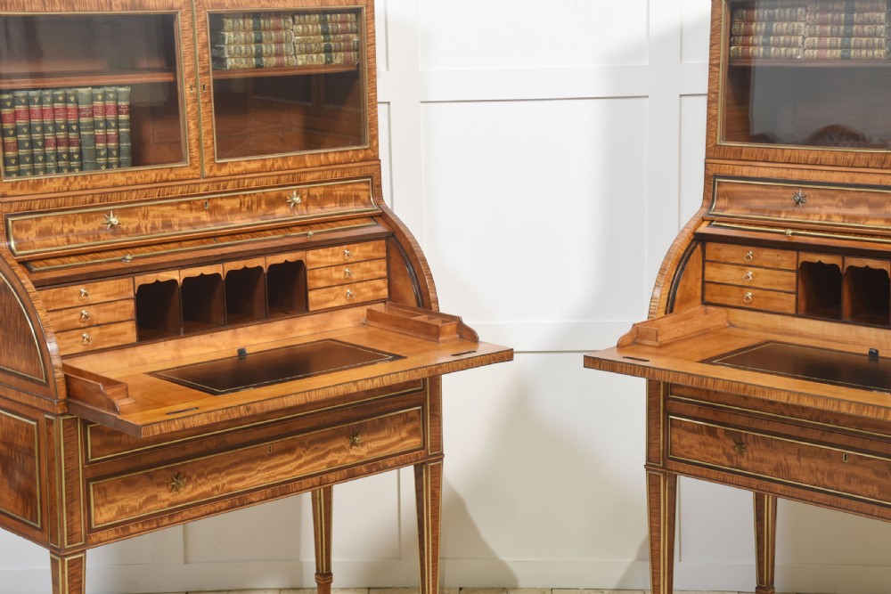 A pair of Georgian satinwood cylinder bureau cabinets with upper glazed doors, roll-top writing sections, and square tapered legs. View XII