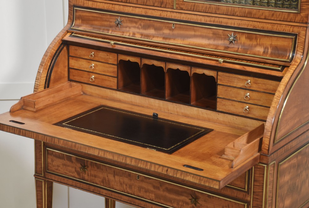 A pair of Georgian satinwood cylinder bureau cabinets with upper glazed doors, roll-top writing sections, and square tapered legs. View XIII