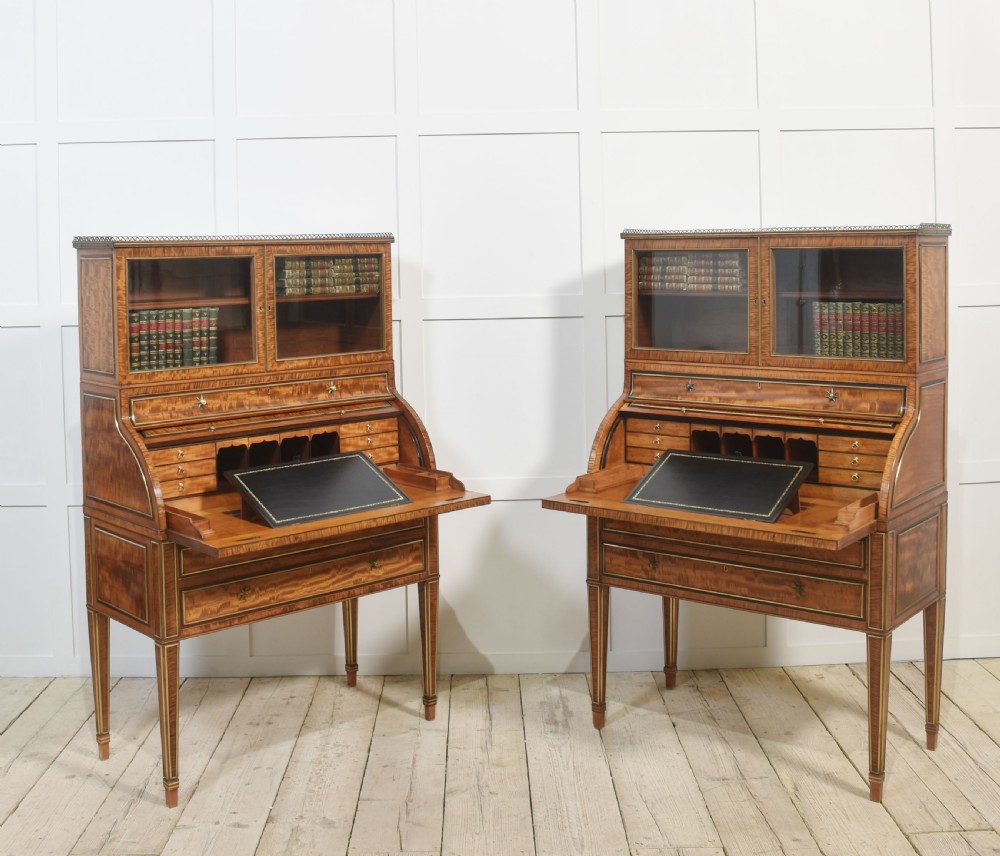 A pair of Georgian satinwood cylinder bureau cabinets with upper glazed doors, roll-top writing sections, and square tapered legs. View XIV