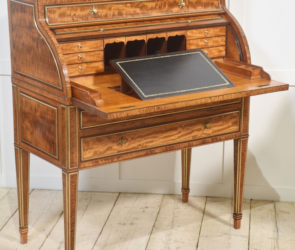A pair of Georgian satinwood cylinder bureau cabinets with upper glazed doors, roll-top writing sections, and square tapered legs. View XV