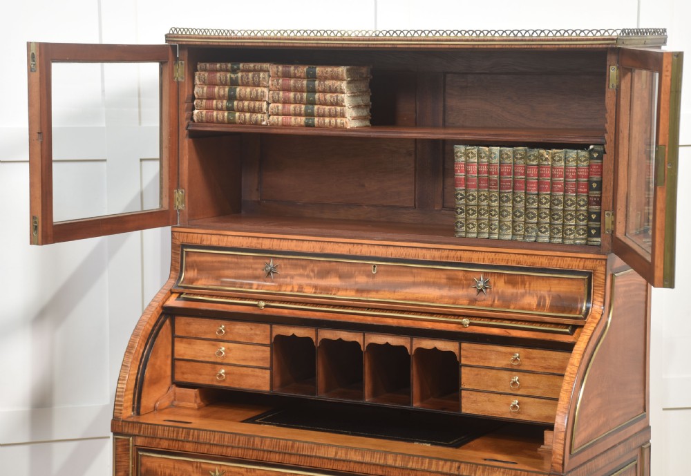 A pair of Georgian satinwood cylinder bureau cabinets with upper glazed doors, roll-top writing sections, and square tapered legs. View XVII