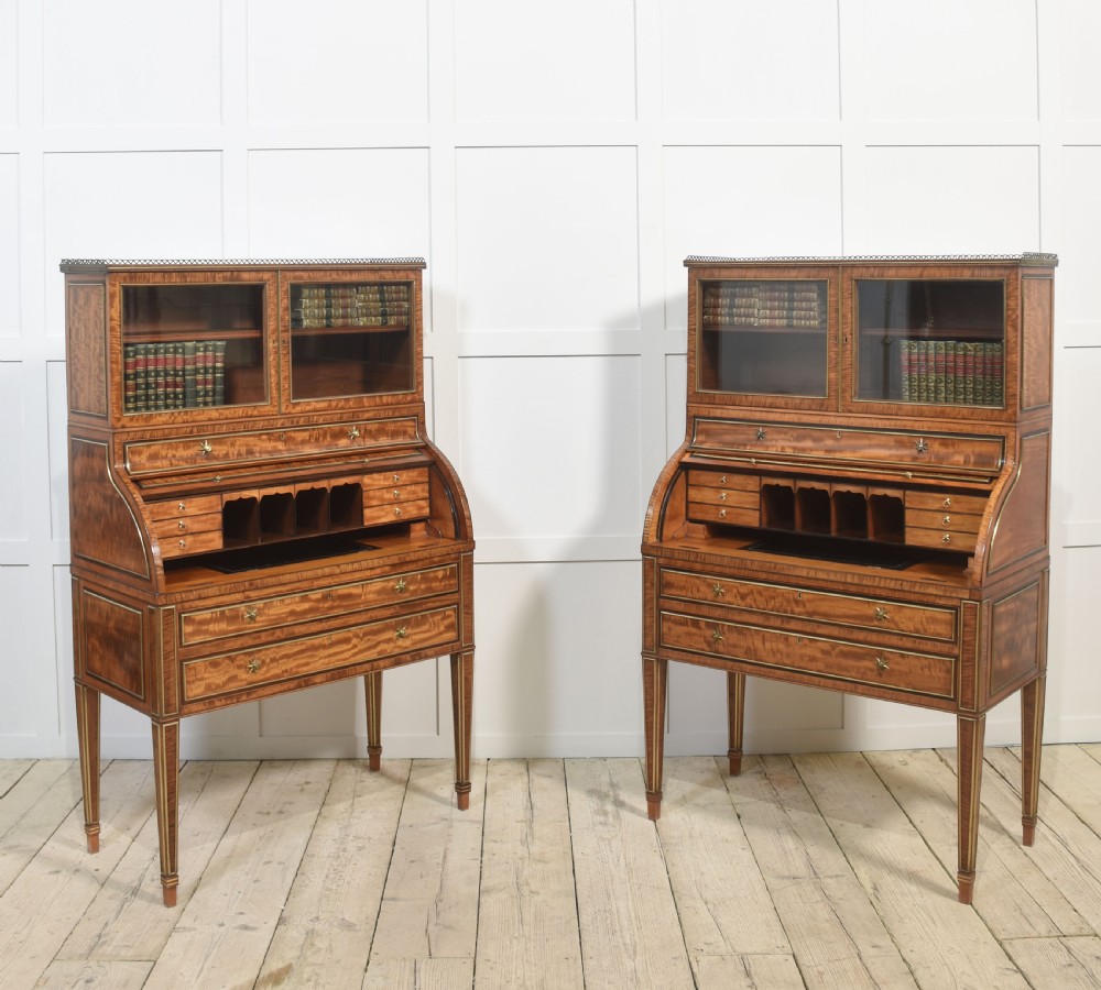 A pair of Georgian satinwood cylinder bureau cabinets with upper glazed doors, roll-top writing sections, and square tapered legs. View XVIII