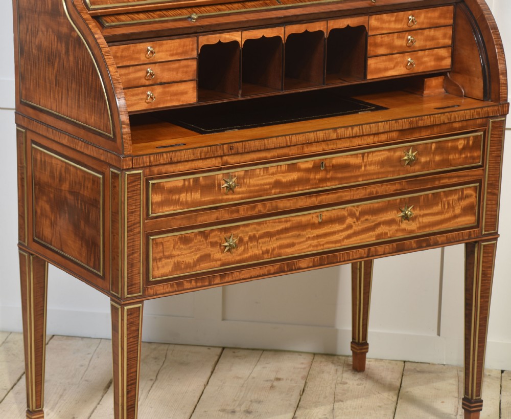 A pair of Georgian satinwood cylinder bureau cabinets with upper glazed doors, roll-top writing sections, and square tapered legs. View XIX