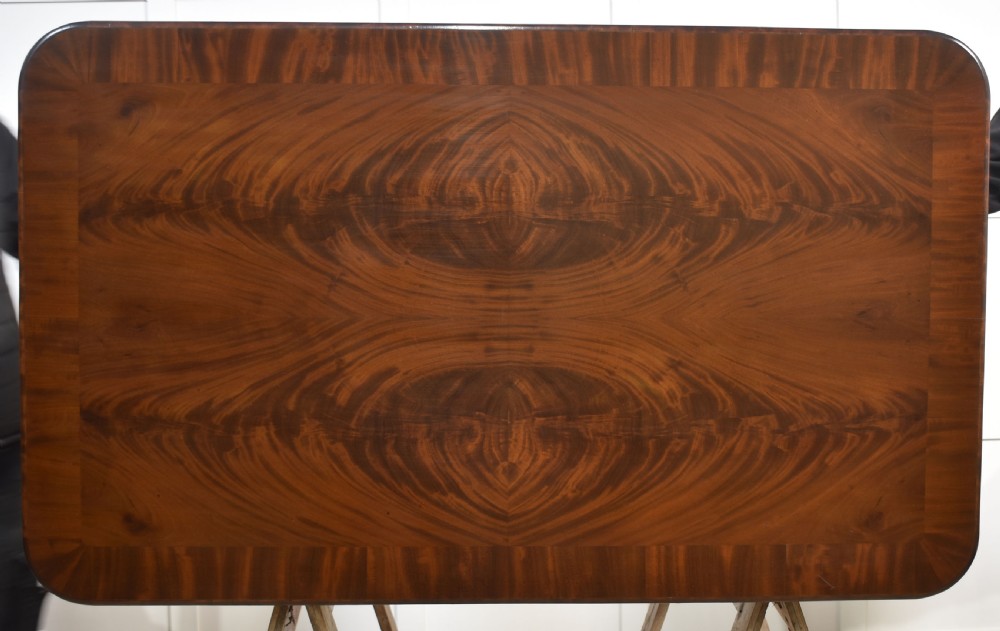 A Victorian mahogany centre table featuring a polished rectangular top with rounded corners, trestle end supports, a spiral-turned stretcher, and scroll feet on castors. View XIII