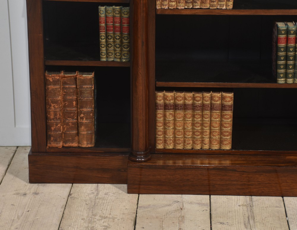 A 19th-century rosewood breakfront open bookcase featuring a pale marble top surface and decorative turned columns flanking open shelves filled with books. View III