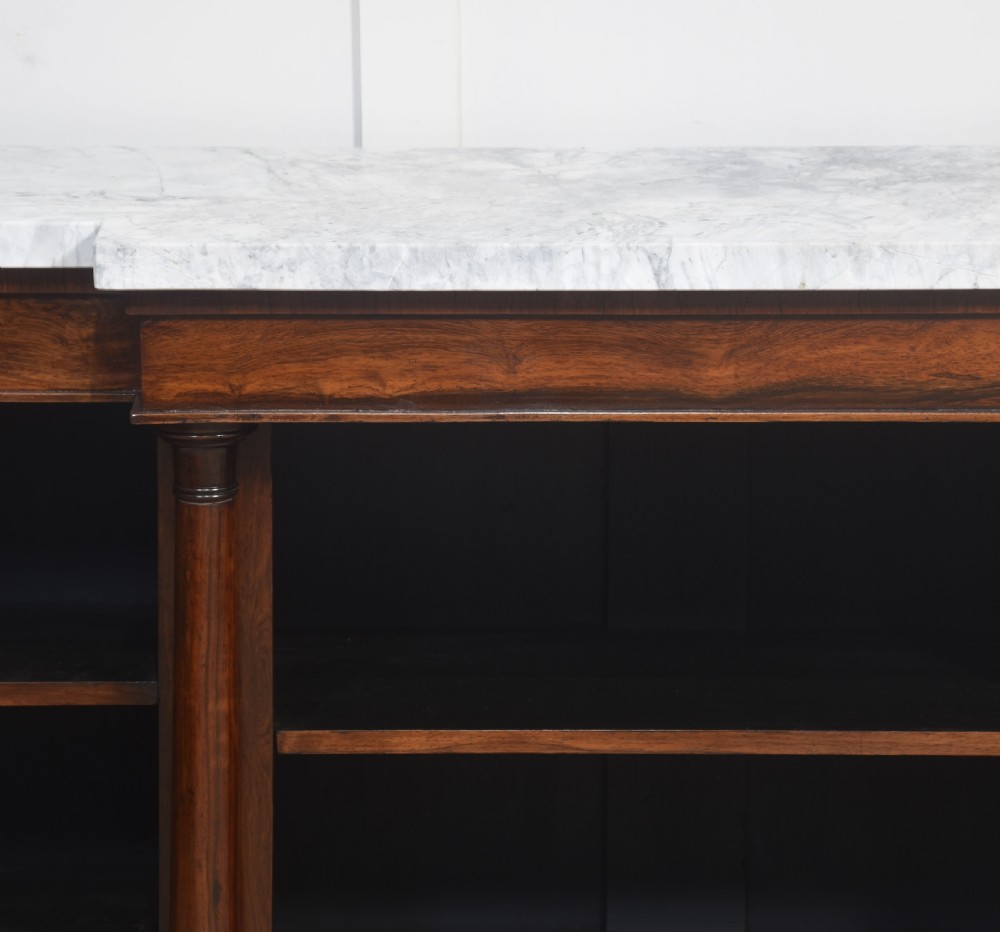 A 19th-century rosewood breakfront open bookcase featuring a pale marble top surface and decorative turned columns flanking open shelves filled with books. View VIII