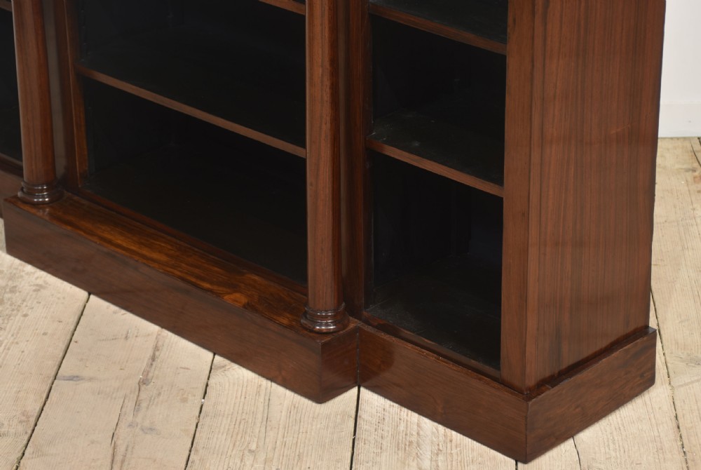 A 19th-century rosewood breakfront open bookcase featuring a pale marble top surface and decorative turned columns flanking open shelves filled with books. View IX